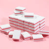 A stack of white and red nail and cuticle buffing files arranged in a pyramid shape.