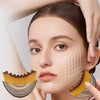 A woman is using a lymphatic contour face brush on her face.