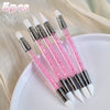 A set of five pink nail art liner brush pens with ultra-fine tips displayed on a white plate.