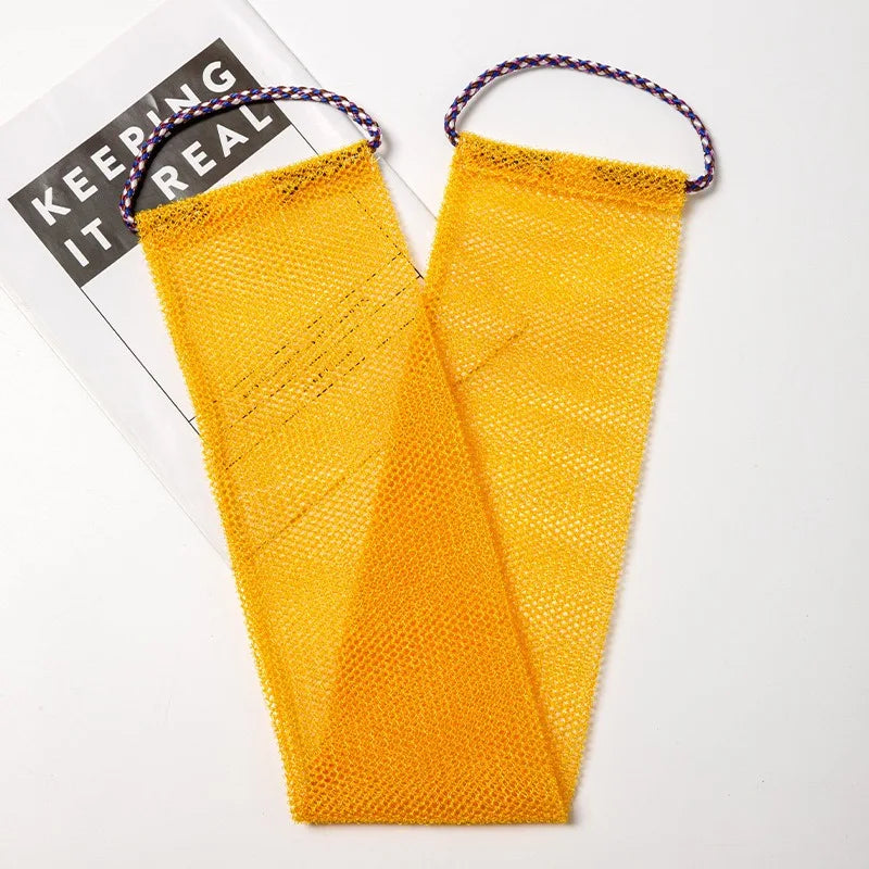 A bright yellow exfoliating African net body scrub sponge with purple string handles.