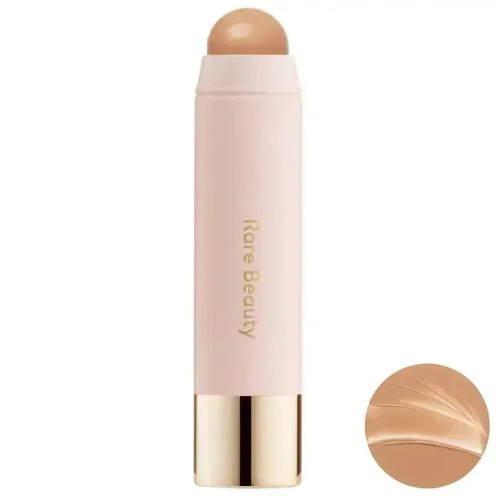 A tube of liquid bronzer contour foundation stick with a pink body and a nude top, shown against a white background.