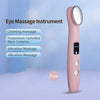 A pink eye massage instrument wand with a silver head and controls, shown against a light blue background.