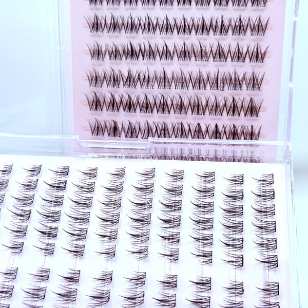 A close-up view of adhesive-free natural look eyelash clusters in various shades and styles.
