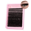 A pink plastic lash tray filled with black wispy lash clusters for eyelash extensions.
