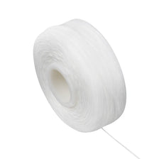 A white spool of dental floss for oral hygiene.