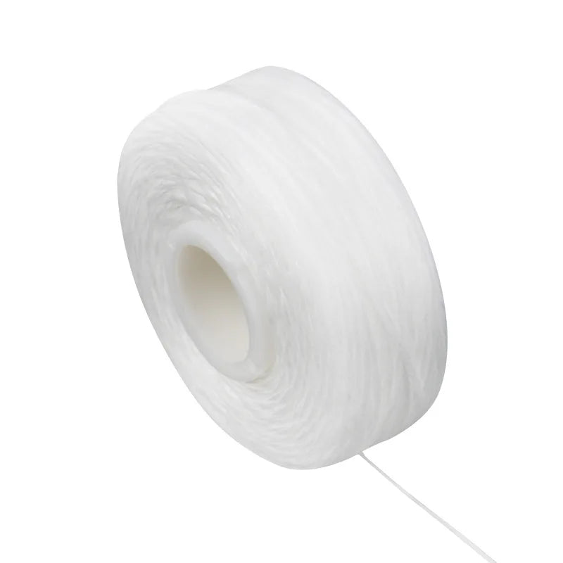 A white spool of dental floss for oral hygiene.
