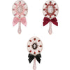 A set of three decorative makeup mirrors with pink and white floral accents and satin ribbons.