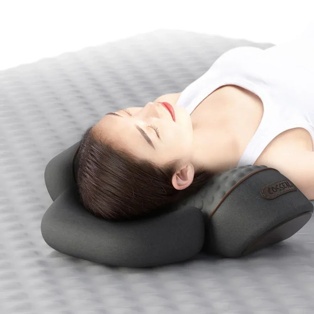 A person is lying down using a therapeutic neck massager for relief and relaxation.