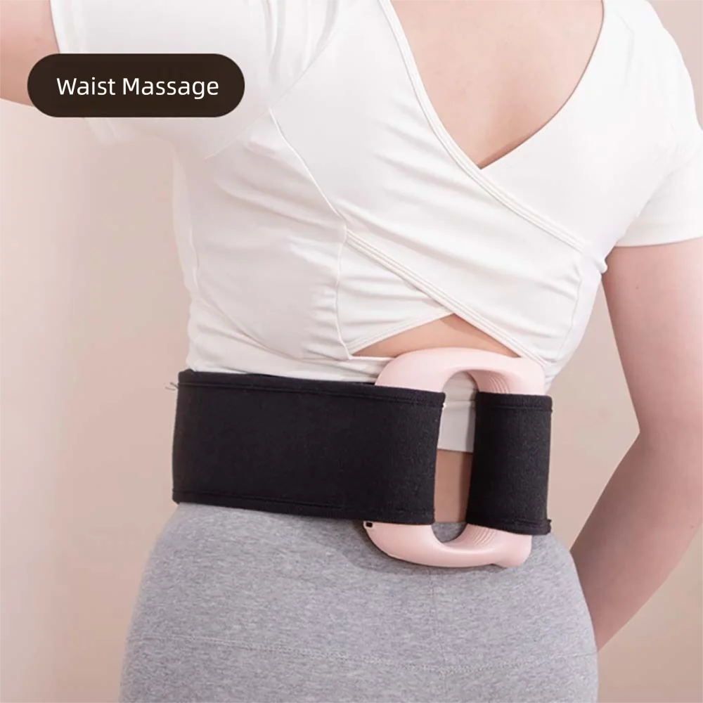 A woman is shown wearing a black fascia massager belt around her waist while wearing a white top.