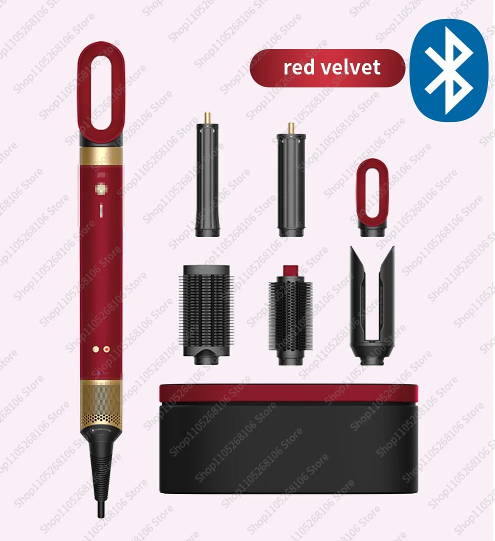 A set of red velvet hair styling tools including a cylindrical dryer, rollers, and attachments.