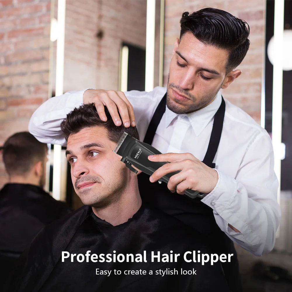 A man is using a professional electric hair clipper on another man's head in a salon setting.