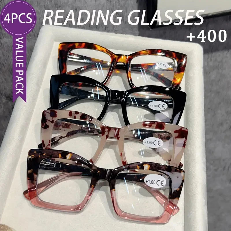 A white box containing four pairs of tortoiseshell reading glasses for presbyopia.