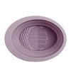 A round, mauve silicone makeup brush cleaner and drying stand with textured surfaces.