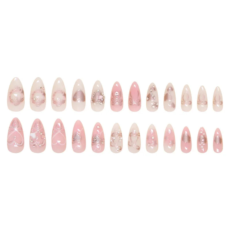 A collection of 24 pink heart pearl press-on fake nails displayed in a row.