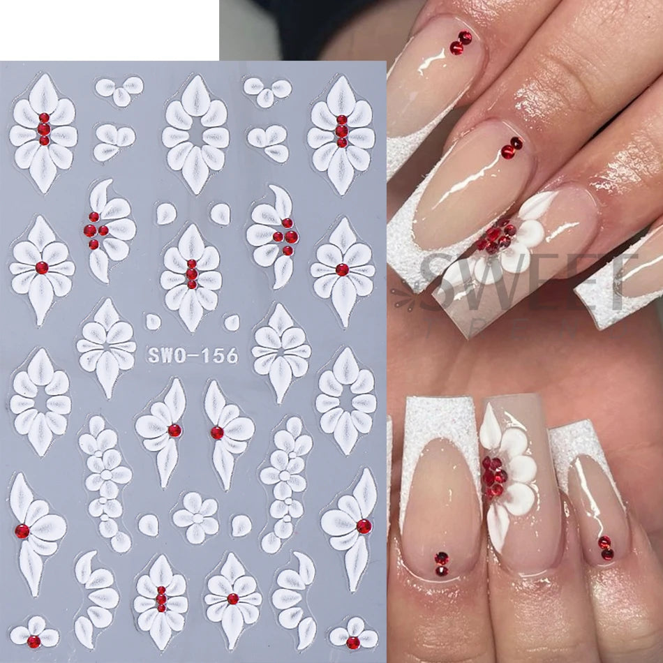 A set of white embossed floral nail stickers featuring red accents on a light gray background.