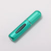 A teal portable refillable perfume bottle with a silver cap, shown diagonally on a white background.