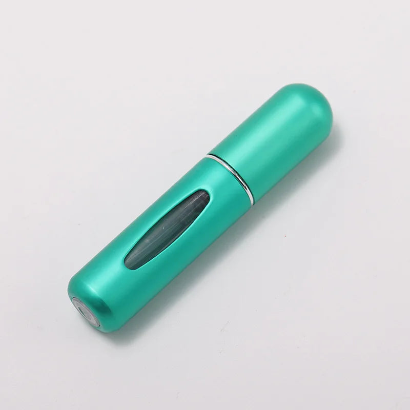 A teal portable refillable perfume bottle with a silver cap, shown diagonally on a white background.