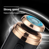 Close-up of a portable electric shaver with a rose gold body and blue guard, highlighting its strong speed feature.