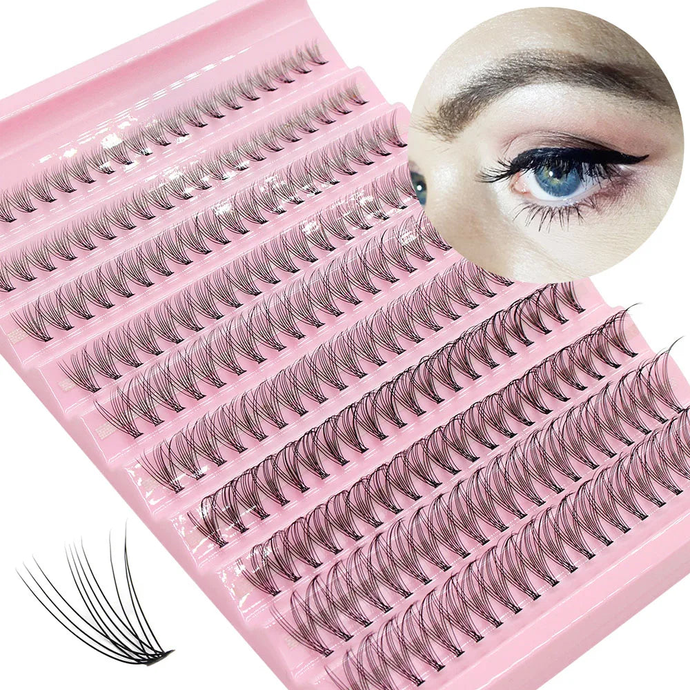 A pink lash tray with numerous synthetic cluster lashes arranged in rows, showing various lash styles.