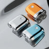Three mini electric beard trimmers or shavers in gold, silver, and light blue resting on a reflective surface.