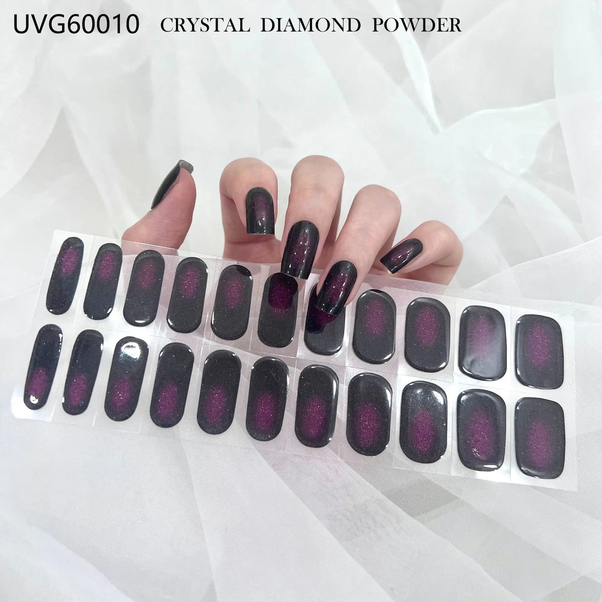 A hand displays UVG60010 crystal diamond powder nail stickers in various shades on a white background.