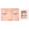 A realistic silicone mannequin head with painted eyes and lashes used for eyelash extension practice.