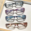 A set of four ultralight anti-blue light reading glasses with various colored lenses displayed on a white surface.