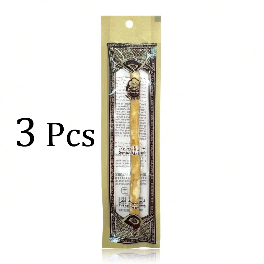 Three traditional wooden miswak toothbrushes packaged in a clear plastic pouch.