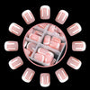 A circular arrangement of nude pink press-on nails with white French tips displayed against a black background.