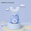 A light blue cartoon-designed electric U-shaped toothbrush for children sitting on a stand against a light purple background.