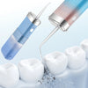 A portable high-pressure oral irrigator device is shown spraying water onto white dental models.