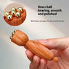 A wooden gua sha tool with brass ball bearings is shown being held, demonstrating its design for facial massage.