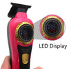 A pink cordless hair trimmer with a gold accent and an LED display showing 100% battery.