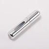 A silver portable refillable perfume bottle shown in a side view against a white background.