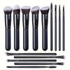 A set of professional makeup brushes in black and gray shades displayed against a white background.
