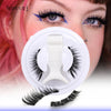 A close-up of a woman applying magnetic mink false eyelashes to her eye, with the product set visible below.