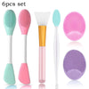 A set of six silicone facial cleansing brushes and mask applicators in various shades of pink, green, and purple.
