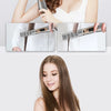 A woman is using a 2-in-1 hot air styling comb for blow-dry, straightening, and curling on her hair.