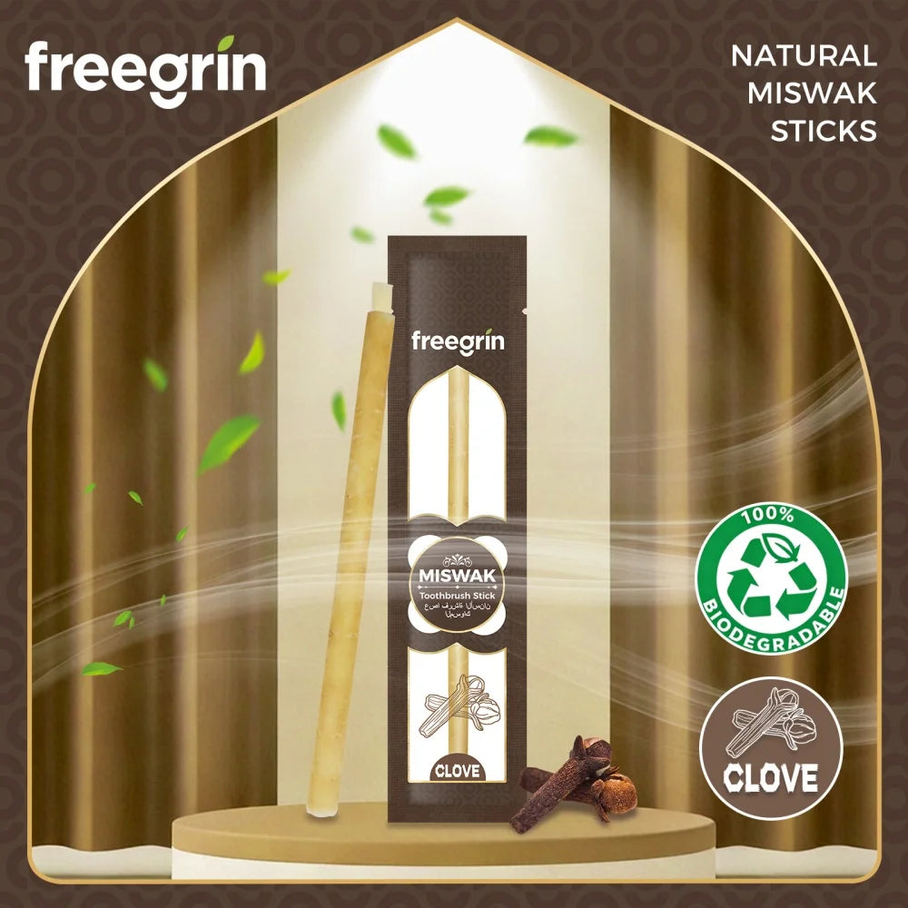 A wooden miswak stick and clove are displayed in a glass case against a brown background.