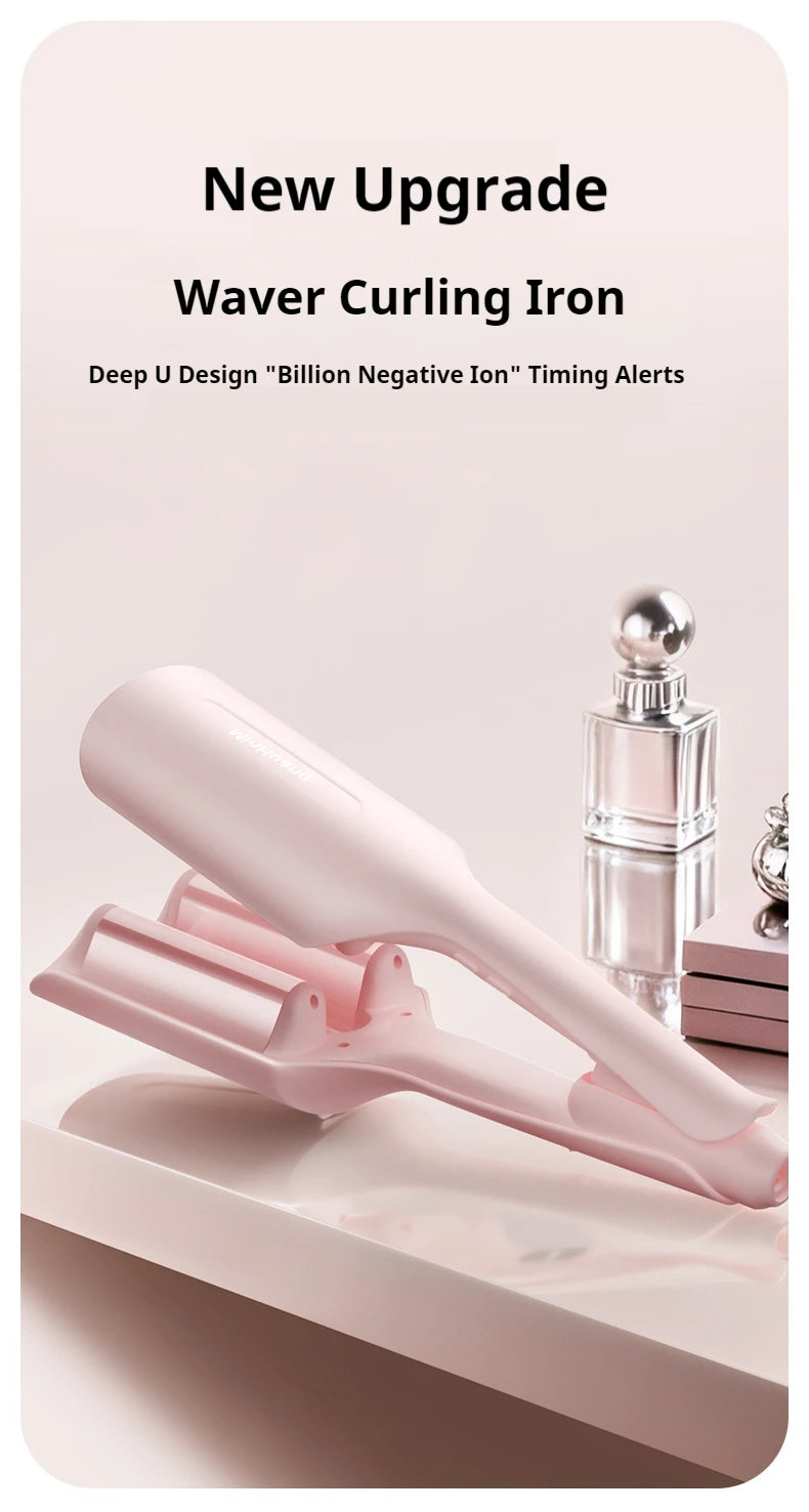 A pink waver curling iron is shown on a white surface next to a glass bottle.