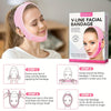 A woman is applying a pink V-Line facial bandage to her face for lifting and firming treatment.