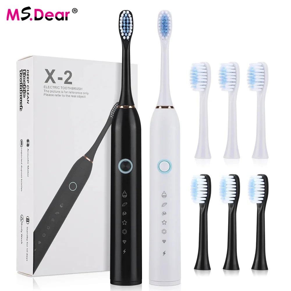 A box and several white electric toothbrushes are displayed, including a detachable brush head.