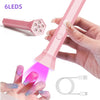 A hand holds a pink cordless mini UV LED nail lamp with 6 LEDs and a charging cable, demonstrating its use for manicures.