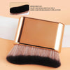 A gold-colored contour foundation brush with dense, short, and dense bristles shown against a light background.