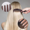 A hand is using a self-cleaning dandruff relief comb with scalp massage on blonde hair, showing the comb and its bristles.