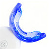 A close-up of a bright blue U-shaped dental whitening tool resting on a white device.