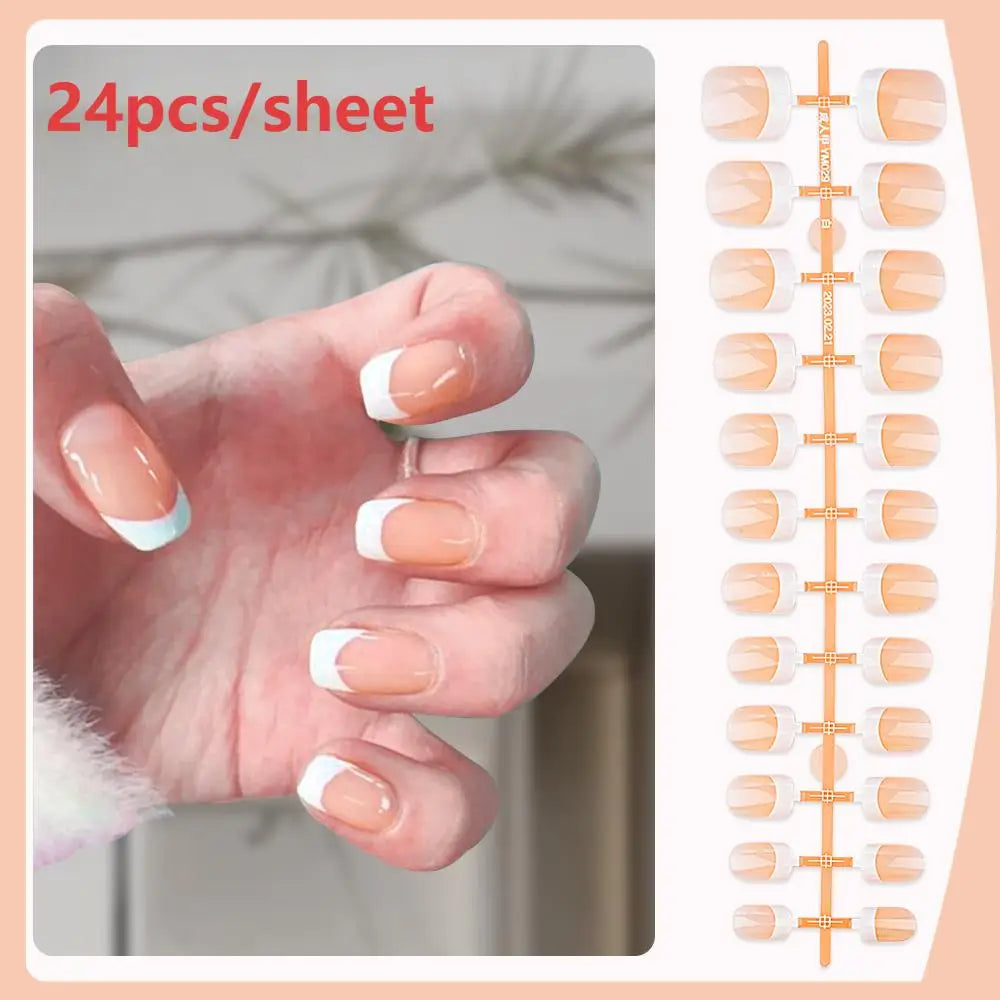 A hand displays a sheet of 24 press-on nails with nude pink base and white French tips.