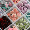 A collection of 3D floral butterfly pearl nail art charms in various shades of pink, purple, and green.