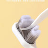 A close-up of a white toothbrush with soft gray bristles is shown against a light background.