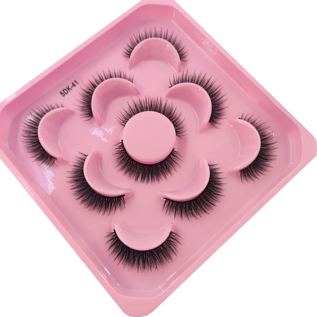 A pink tray containing a set of artificial mink eyelashes for eye extensions.